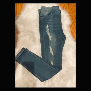 White washed high waist blue jeans with rips.